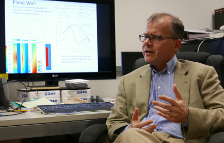 Professor Erich Schneider being interviewed at his desk