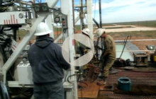 Image from the title slide of Jim Malewitz' presentation at UT Energy Symposium, showing men in hard hats working on energy infrastructure