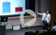 Richard Meyer gestures toward a screen displaying a chart while speaking at UT Energy Symposium